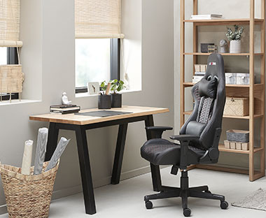 Drewniane meble w domowym biurze i czarny, wygodny fotel 