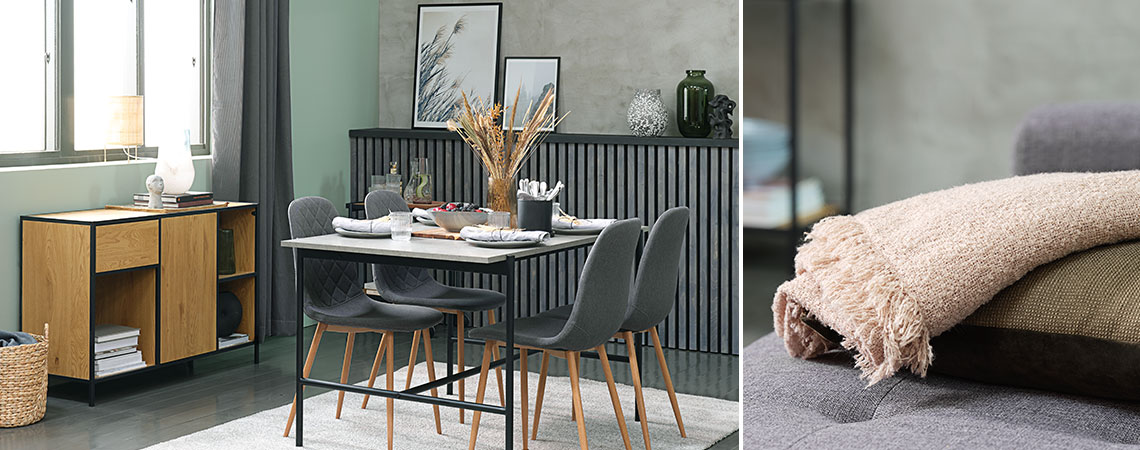Salon ze stołem o wyglądzie betonu, szarymi krzesłami i dębowym kredensem