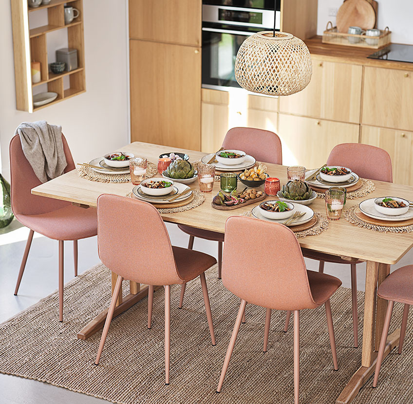 Delikatne brzoskwiniowe krzesła wokół stołu w kuchni