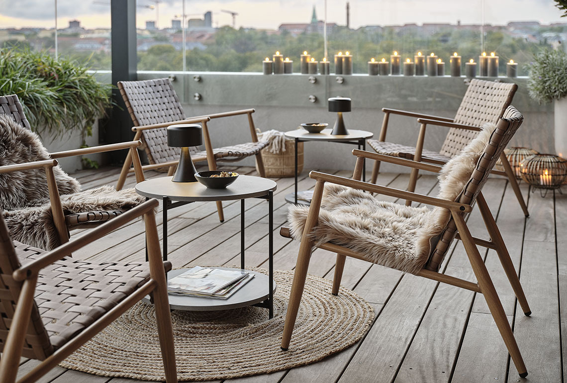 Leżaki ogrodowe i stoliki na przytulnym balkonie 