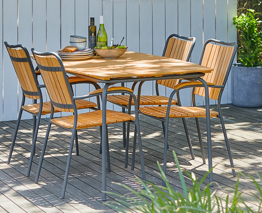 Gaarden set with wooden garden table and 4 wooden garden chairs on a patio 