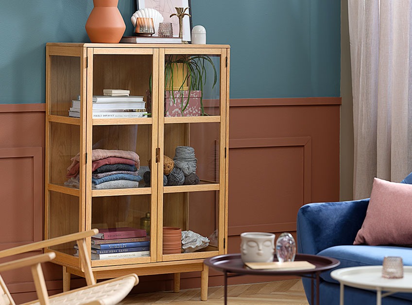 LANGELINJE display cabinet filled with décor and pretty knick knack Oak display cabinet in colourful living room
